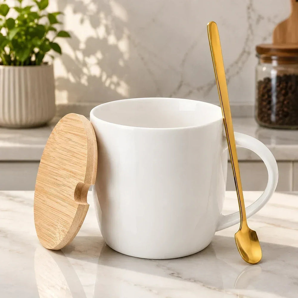 White printed ceramic mug with a wooden lid and gold spoon on a marble counter